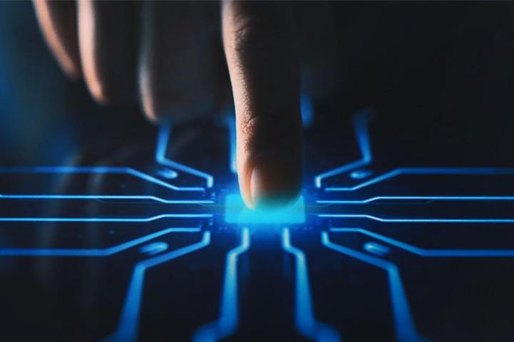 finger pressing down on a blue button with tech-style lines around it