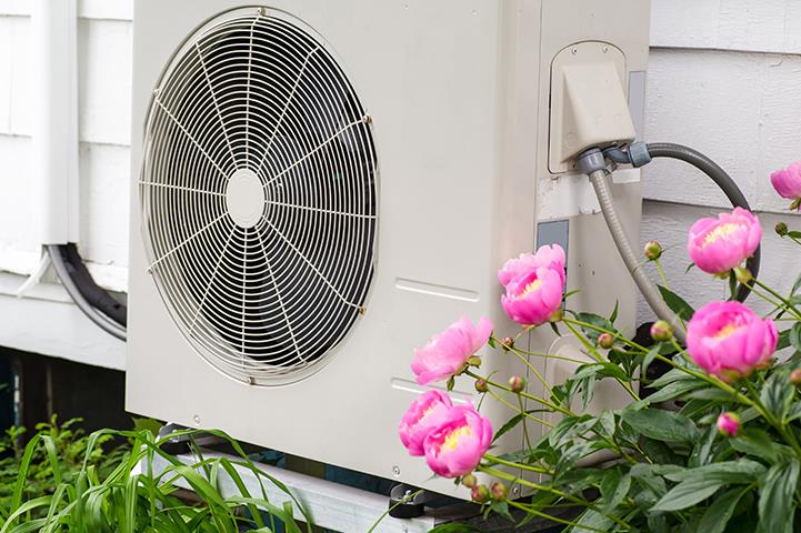 air conditioning heat pump unit on side of a home