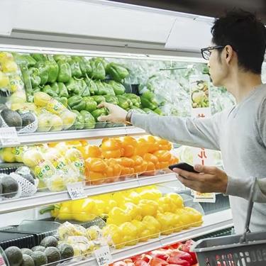 person shopping produce at the grocery store