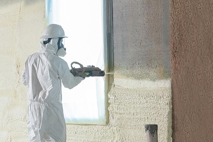 person spraying polyurethane foam insulation