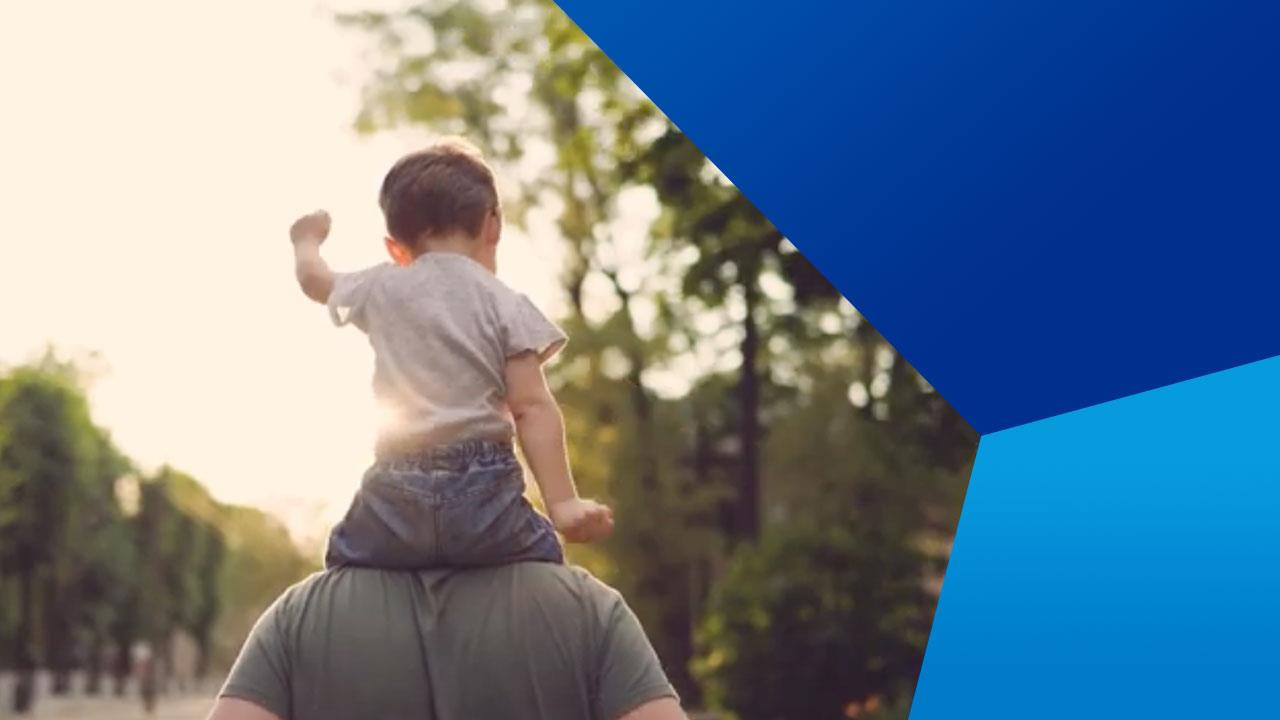 Child riding on parents shoulders